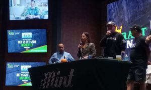 DraftKings Senior Director of Gaming Partnerships Krista Thomas speaks to the crowd at The Mint Cumberland mobile launch event Thursday. KSR host Matt Jones (right) and The Mint Cumberland General Manager Henry Graffeo (left) joined her on stage.