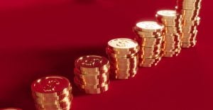 a series of stacks of gold coins on a red background