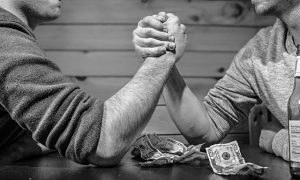 Friends betting arm wrestling