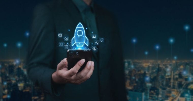 Digitized Rendering of a Rocket Rises From Cell Phone In Man's Hand