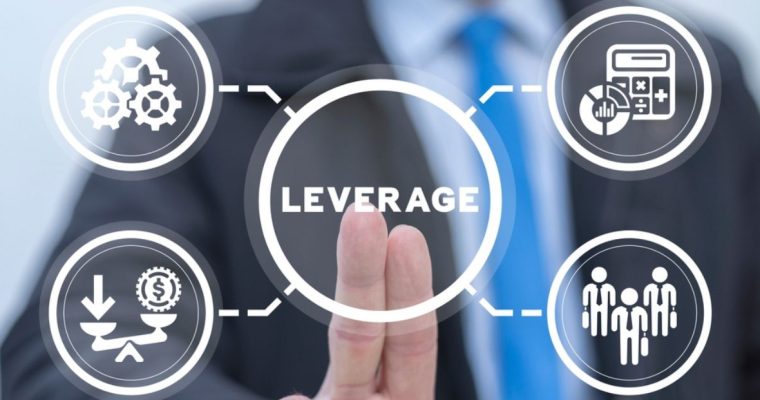 Digital Screen with Word "Leverage" in Center with Man in Suit Pointing to it