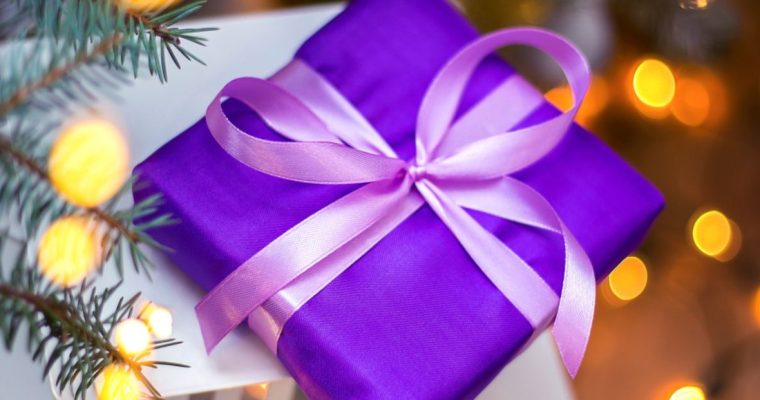 Close Up of Purple Wrapped Christmas Gift with Ribbon