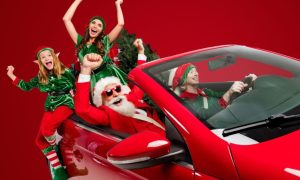 Red Convertable Car Filled with Excited Santa and Christmas Elves