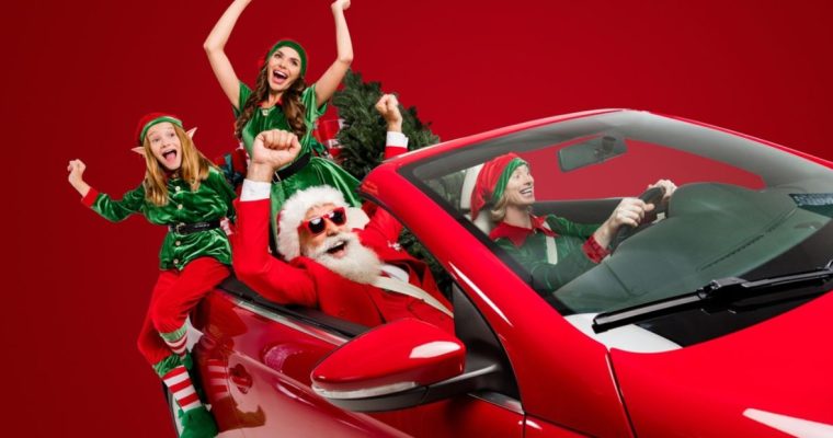 Red Convertable Car Filled with Excited Santa and Christmas Elves
