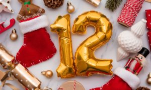 Christmas Decorations Displayed On Table with Number 12 Gold Balloon at Center