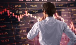 Man Thinks While Facing Oversized Financial Stock Graph