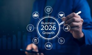 Man Using Pen Points to Business 2026 Growth Digital Overlay While Holding Cell Phone