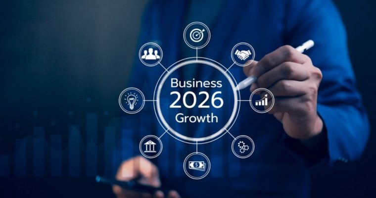 Man Using Pen Points to Business 2026 Growth Digital Overlay While Holding Cell Phone