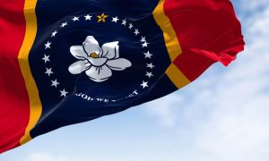 The state flag of Mississippi is waving in the wind.