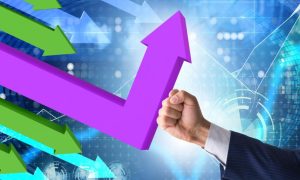 Fist Wearing Business Suit Changes Direction of Purple Downward Trending Arrow