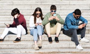 Young Minds Stare at Cell Phones Hooked on Dompamine-Enducing Short-Term Rewards