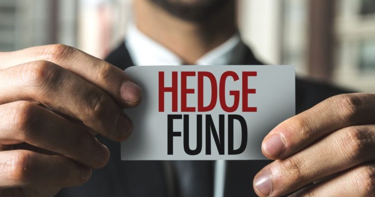 Card Reading Hedge Fund Held by Man in Black Suit