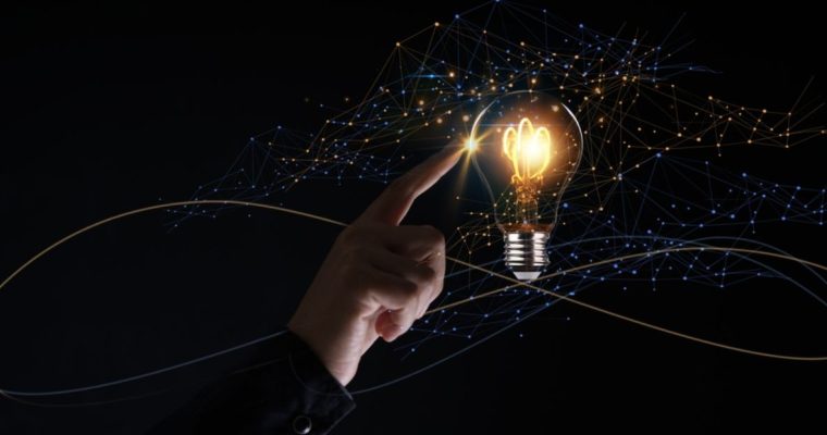Edison Bulb Glows With Sparkles Flying Around and Man's Finger Toucing it