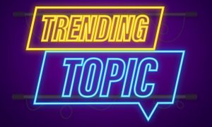 Illustration of Neon Light in Bubble Speech Shape Reads Trending Topic in Yellow and Blue Hues