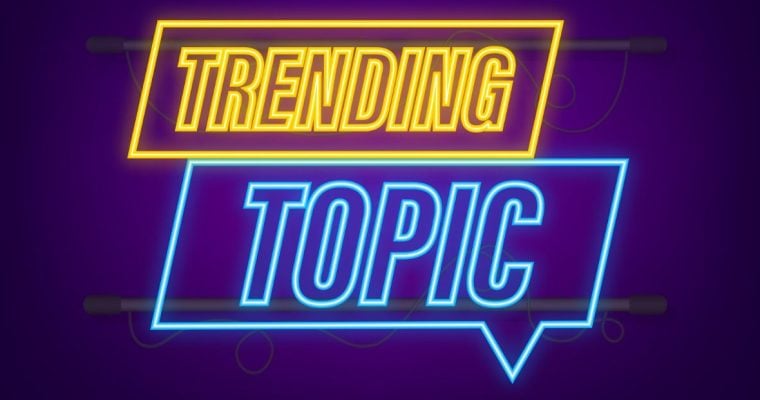 Illustration of Neon Light in Bubble Speech Shape Reads Trending Topic in Yellow and Blue Hues