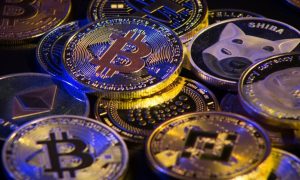 Blue Light Shines on Pile of Gold Coin Crypto Currency