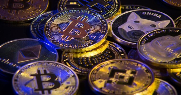 Blue Light Shines on Pile of Gold Coin Crypto Currency