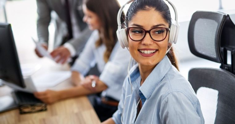 Attractive Young Woman Works As Call Center Agent Using White Headphones
