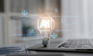 Silver Laptop, Light Bulb With AI Computer Circuit and Paper with Bar Graph Sit on Desk
