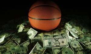 Sports Betting Concept with Basketball Sitting in Front of Pile of American Cash