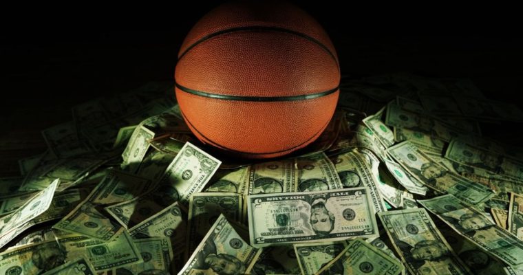Sports Betting Concept with Basketball Sitting in Front of Pile of American Cash