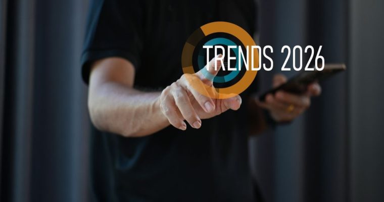 Man in Black T-Shirt Points to Screen With Yellow and Blue Loading Circle and Trends 2026 Text