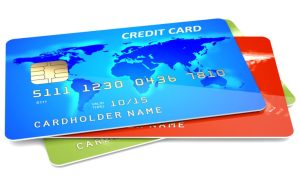 Three Colorful Credit Cards Sit in a Pile on White Background