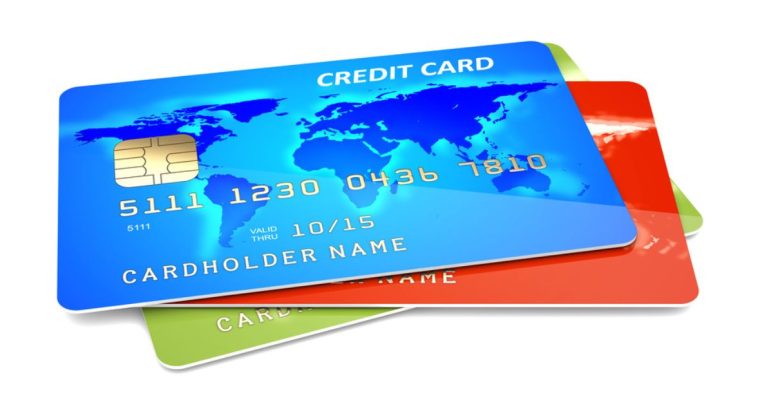 Three Colorful Credit Cards Sit in a Pile on White Background