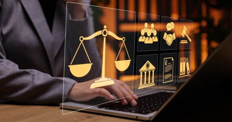 Person in Suit Uses Laptop And Digital Icons Overlay Displaying Legal Concept