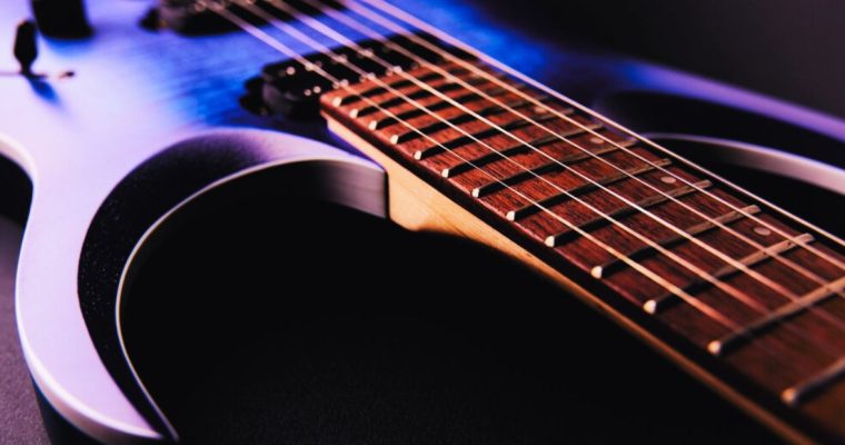 Close Up Of Wires on Purple Electric Guitar