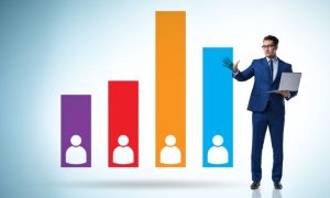 Colorful Bar Graph with People Figures and a Man in a Blue Suit Standing on the Side