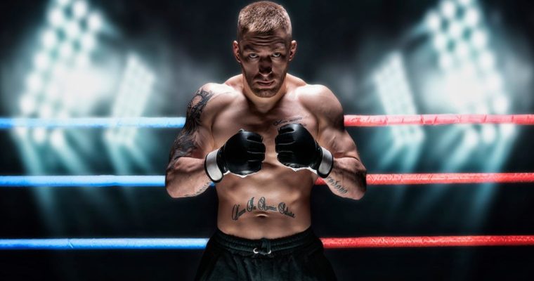 UFC Fighter Poses With Fists To Chest Inside Ring