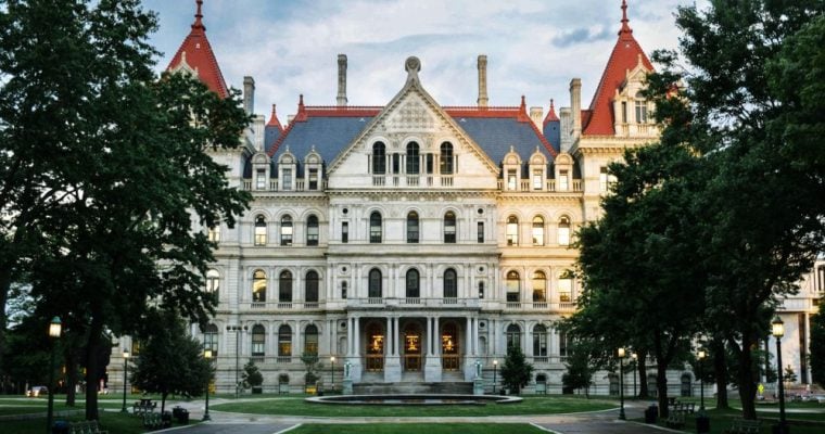 Green Grass and Trees Line the Front of the Capitol Building in Albany, New York