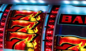 Close Up of Slot Machine Reel with Triple 7's and Bar Symbol