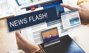 Man Holds iPad with News Flash! Text Box and News Articles Displayed