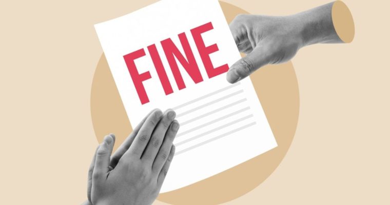 Hand Holds White Paper With Fine in Red Letters and Hands Praying