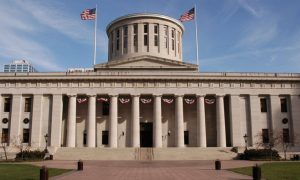 Blue Skies Behind and American Flags Hang at the Capitol Building in Ohio