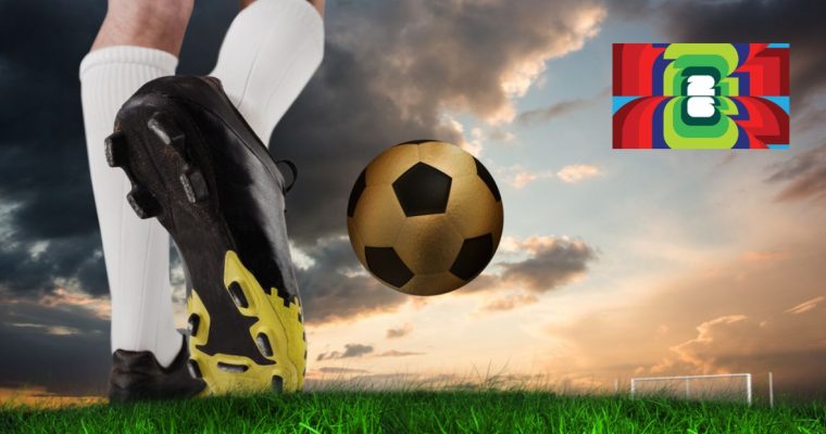 Cloudy Skies on Soccer Field with Close Up of Player's Shoes and Golden Soccer Ball
