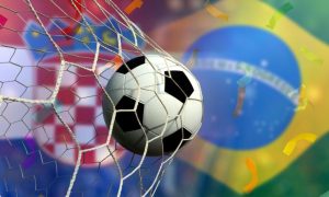 Soccer Ball Hits Back of Net with Flags of Brazil and Croatia in Background