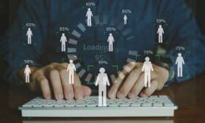 Man Using Laptop Background to Digital Overlay of Human Figures With Percentages Above Heads