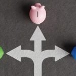 3 White Arrows Point to Piggy Banks Going In Different Directions
