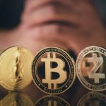 Man's Folded Hands Behind 5 Gold Coins of Cryptocurrency