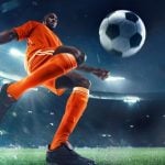 Young Black Male Soccer Player Gets Ready to Kick Ball on the Field