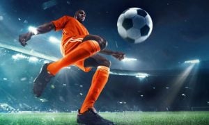Young Black Male Soccer Player Gets Ready to Kick Ball on the Field