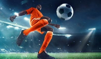 Young Black Male Soccer Player Gets Ready to Kick Ball on the Field