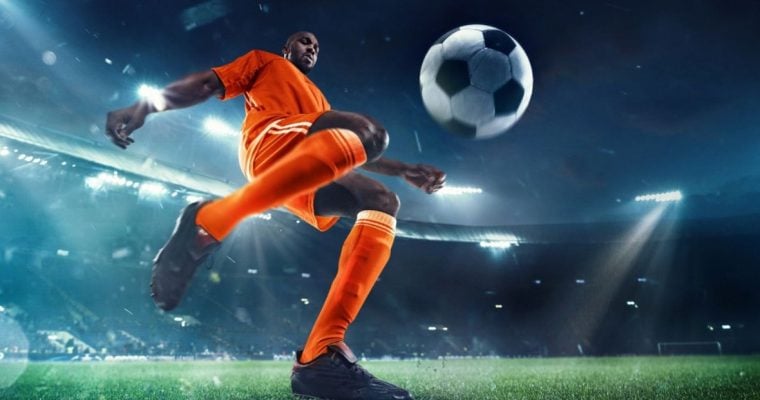 Young Black Male Soccer Player Gets Ready to Kick Ball on the Field