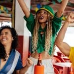 Three Friends Celebrating and Socializing in a Vibrant Outdoor Atmosphere