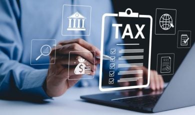 Digital Icons Representing Taxes and Finances Overlay Image of Man on Laptop Pointing with Pen