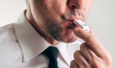 Man in White Shirt and Black Tie Blows White Whistle