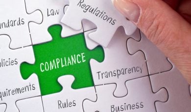 Green Background to White Puzzle Reads Compliance with Other Related Words Printed on Seperate Puzzle Pieces